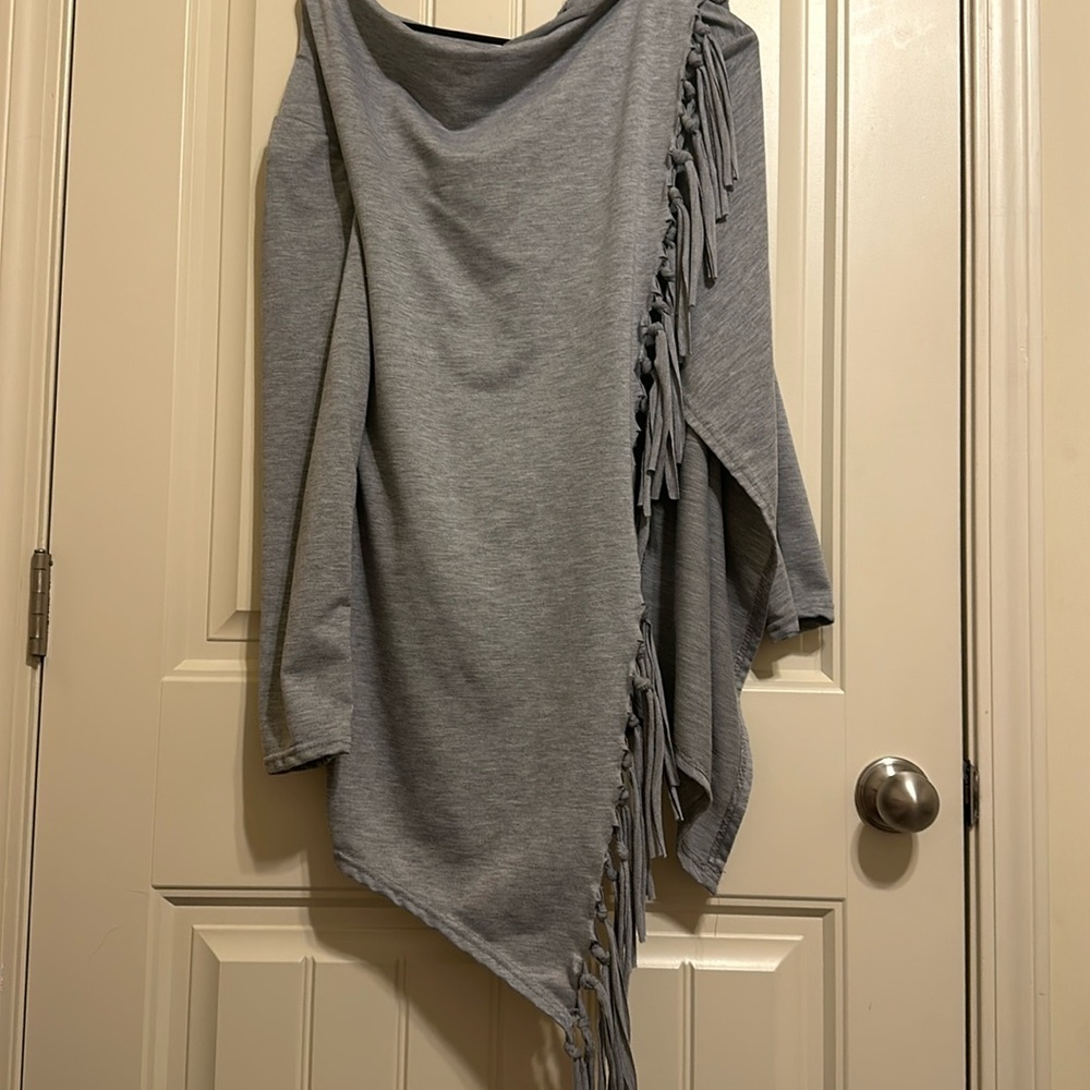 Cute boutique sweater with fringe! Light weight and very cozy! Never worn